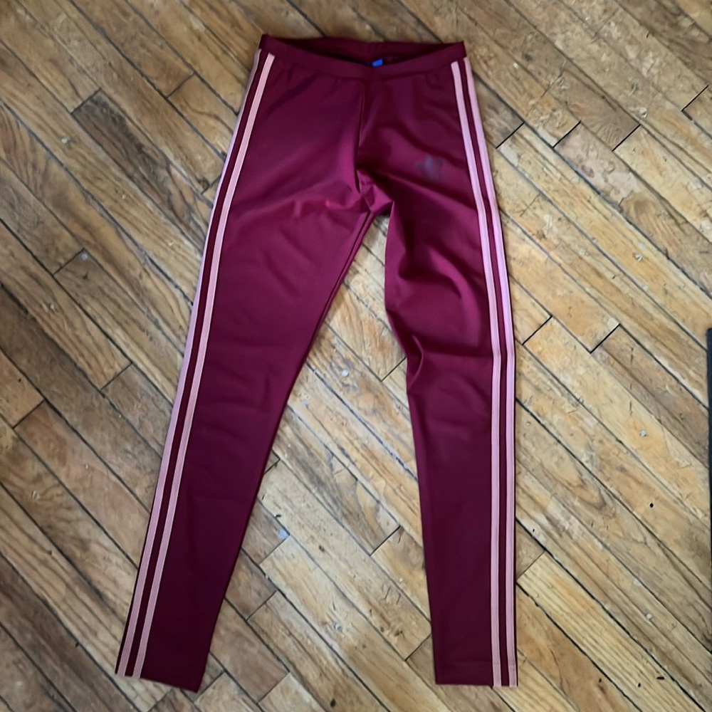 Adidas dusty rose stripes on maroon.